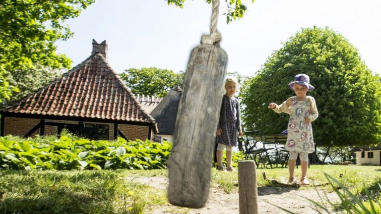 Two little girls trying the old village game 'gallows game'